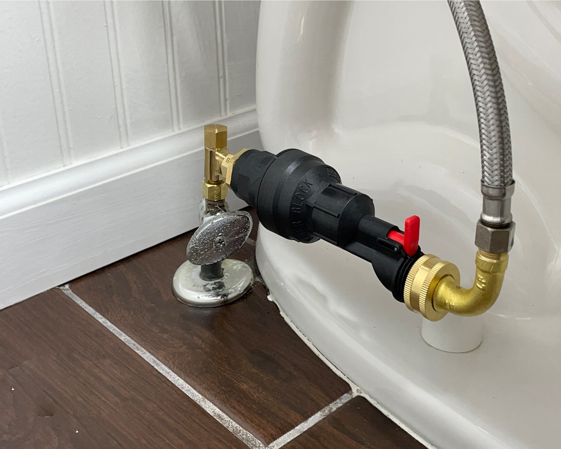 Picture of the Water Block Toilet Shutoff Kit installed on a toilet. The configuration is connected to the toilet water supply valve.