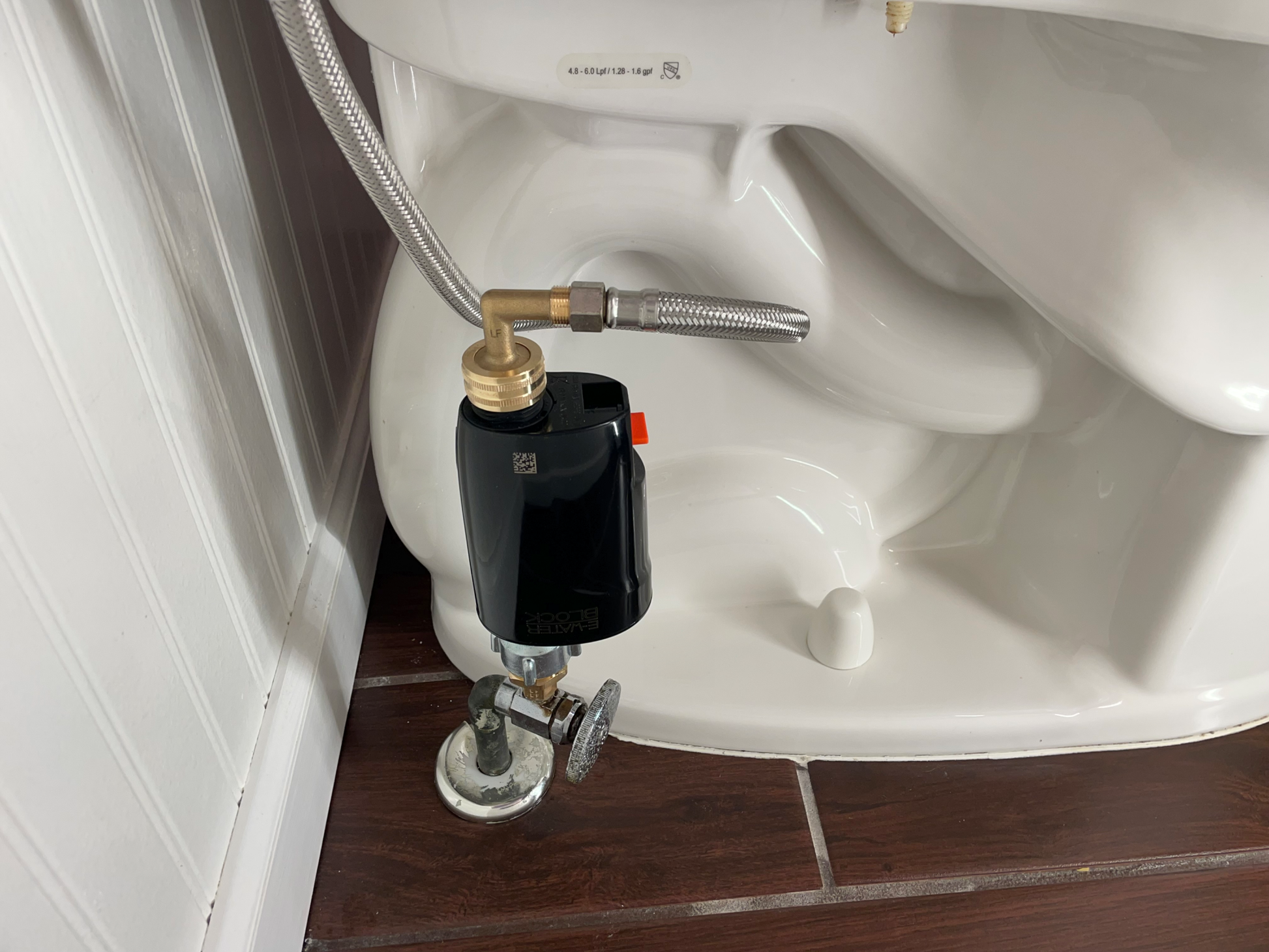 Eltek E-WaterBlock installed in the vertical orientation on a actual toilet. Toilet protection device. Anti-flood technology.