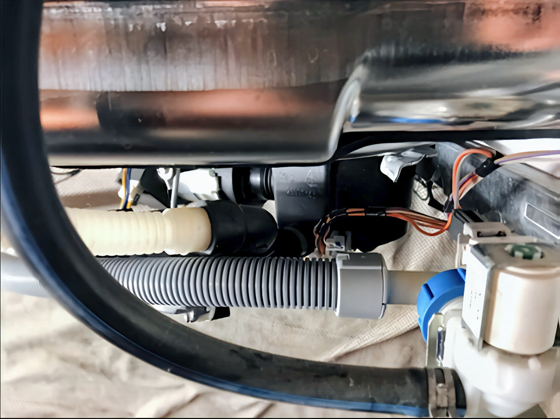 Close-up view of the Flood Prevention Hose connected to a dishwasher’s inlet water valve via a 3/4" GHT connection. Available in 5 ft. or 7 ft. lengths, it prevents water damage by stopping leaks caused by line bursts. Connects securely between the water stop valve and the dishwasher inlet.