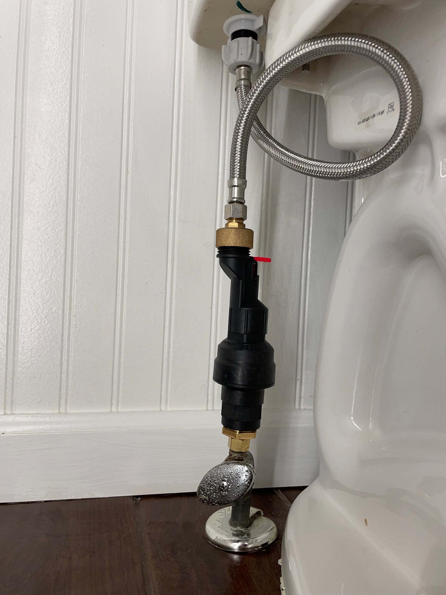 Water Block water shutoff device and reset tool accessory installed in a vertical position on a toilet. Stops running toilets and water leaks downstream if the device.