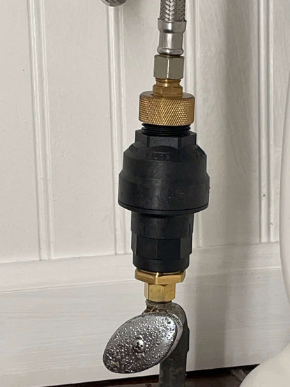 A toilet leak detection device is installed on a toilet to detect leaks. The device is connected to the supply valve and to the toilet tank with 3/8" brass fittings. The device uses a sensor to detect water leaks. If a leak is detected, the device will activate the shutoff valve to prevent flooding and water damage.